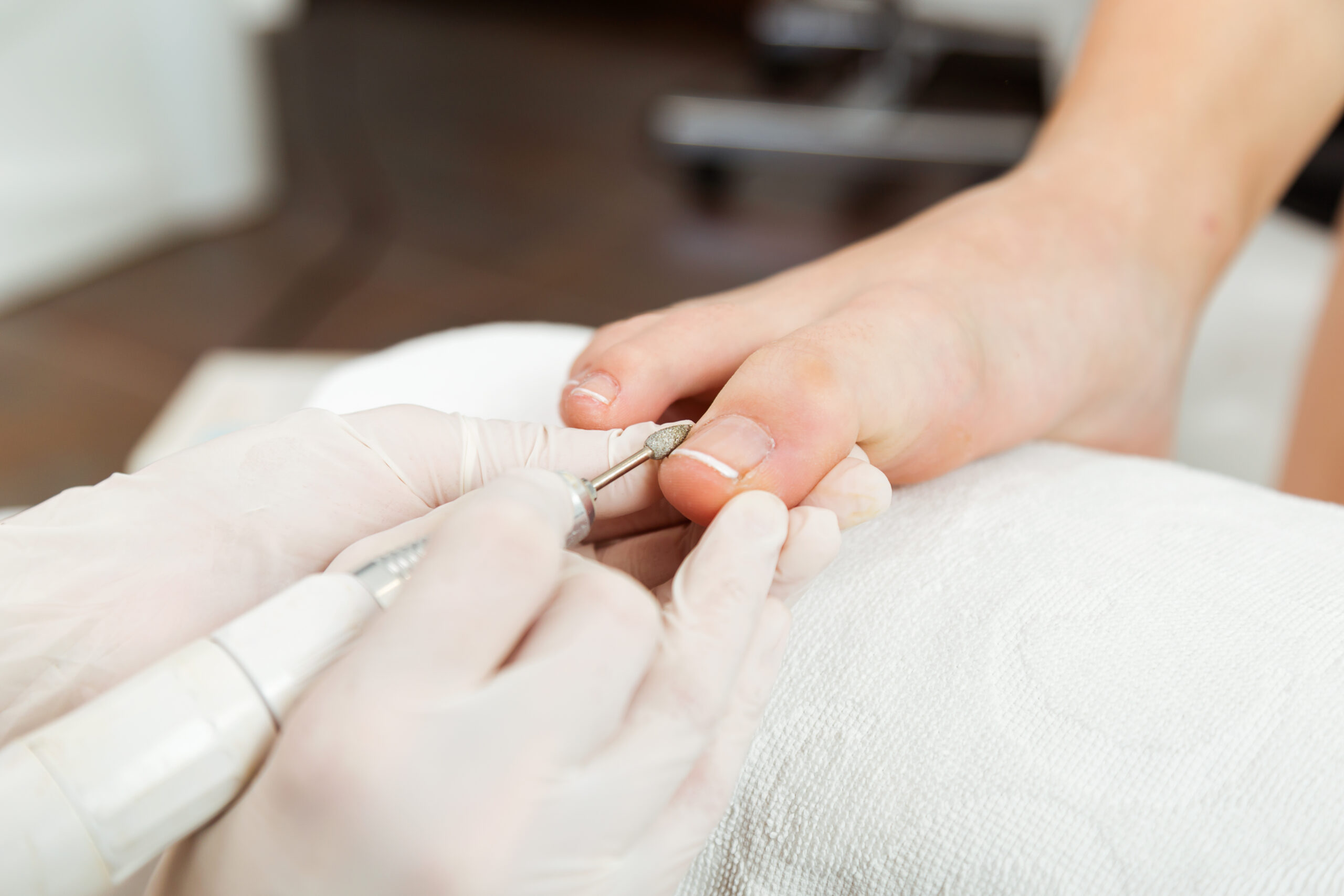 Young woman doing pedicure in salon. Beauty concept. Portrait of young woman doing pedicure in salon. Beauty concept.